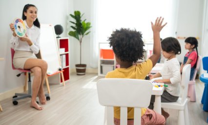 boy raising hand to answer