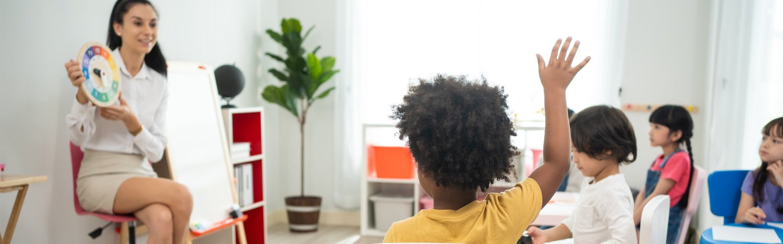 boy raising hand to answer